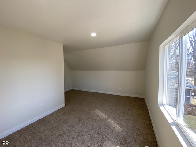 bonus room with lofted ceiling, carpet flooring, and baseboards