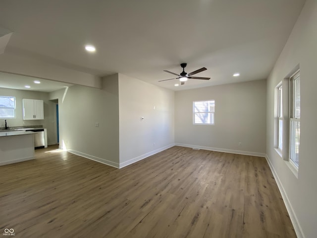 unfurnished room featuring recessed lighting, baseboards, wood finished floors, and a ceiling fan