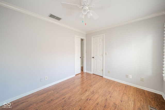 unfurnished room with visible vents, baseboards, ceiling fan, and wood finished floors