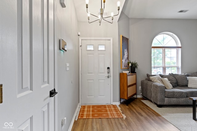 12612 Clearview Ln, Indianapolis, IN 46236 - foyer entrance with wood finished floors, a chandelier, and baseboards