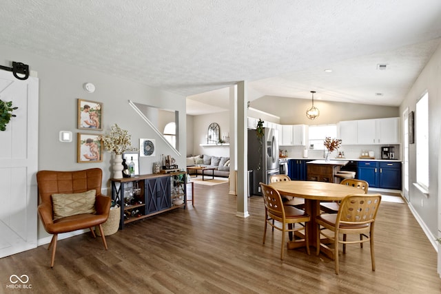 12612 Clearview Ln, Indianapolis, IN 46236 - dining area featuring wood finished floors, a textured ceiling, and vaulted ceiling