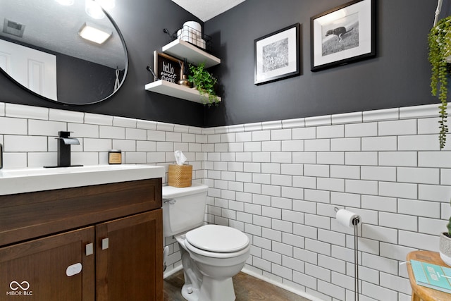 12612 Clearview Ln, Indianapolis, IN 46236 - half bath featuring toilet, tile walls, vanity, and wainscoting
