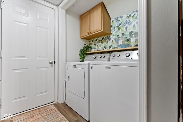 12612 Clearview Ln, Indianapolis, IN 46236 - laundry room featuring independent washer and dryer, cabinet space, wood finished floors, and wallpapered walls
