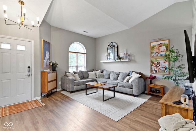 12612 Clearview Ln, Indianapolis, IN 46236 - living room with light wood-style flooring, a chandelier, lofted ceiling, and baseboards