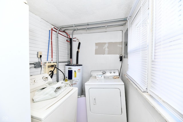 laundry room with plenty of natural light, a textured ceiling, water heater, separate washer and dryer, and laundry area