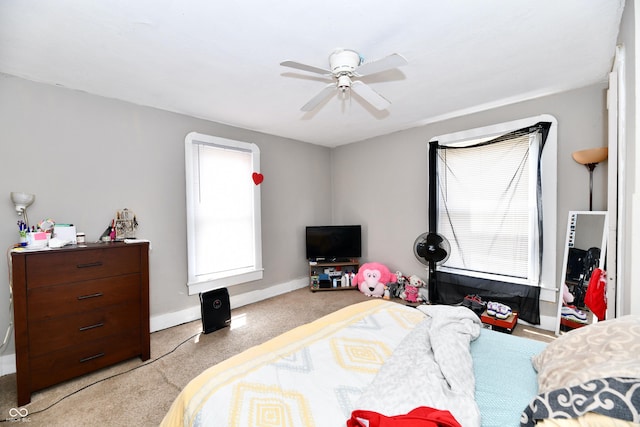 carpeted bedroom featuring ceiling fan and baseboards