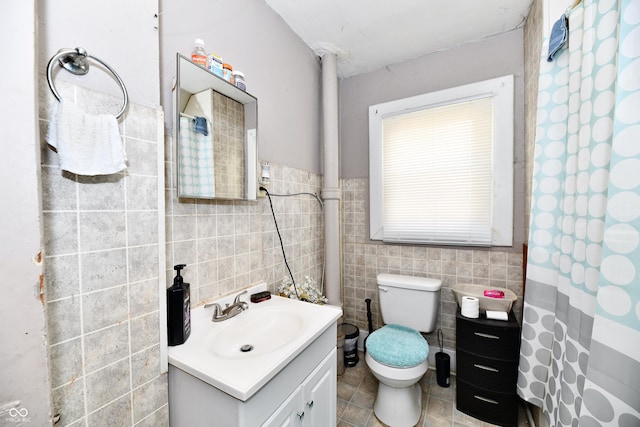 full bathroom with vanity, a shower with curtain, tile patterned flooring, tile walls, and toilet