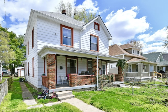 view of front of house with brick siding, a porch, fence private yard, roof with shingles, and a chimney