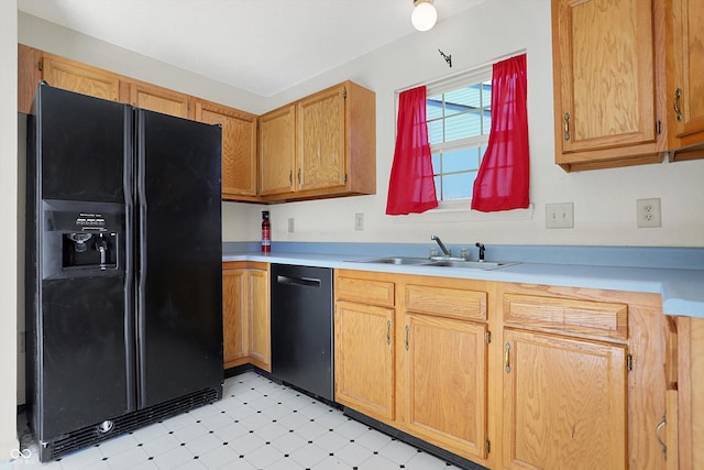 kitchen featuring light floors, a sink, light countertops, black fridge with ice dispenser, and dishwasher