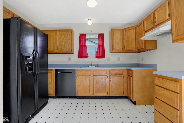 kitchen featuring under cabinet range hood, black fridge with ice dispenser, stainless steel dishwasher, light countertops, and light floors