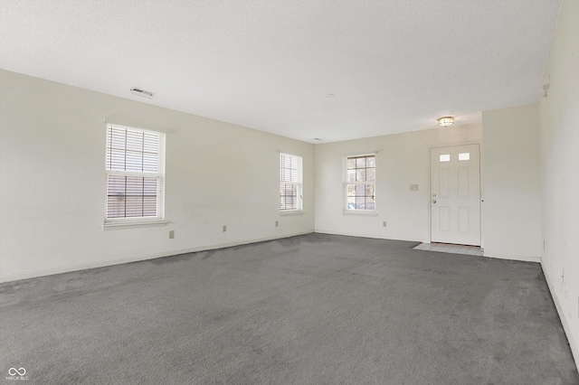 interior space featuring visible vents and a textured ceiling