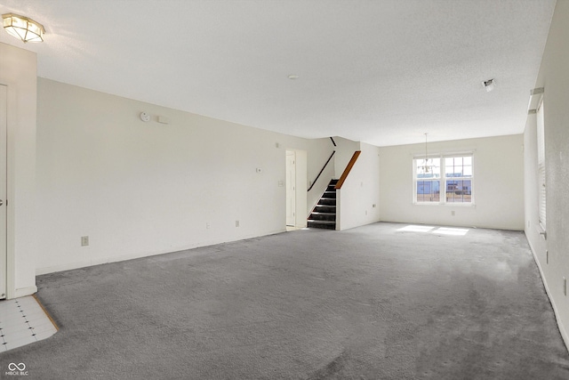 unfurnished living room with stairway and carpet