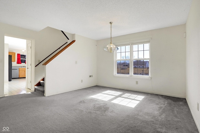 interior space with stairway, baseboards, a chandelier, and a textured ceiling