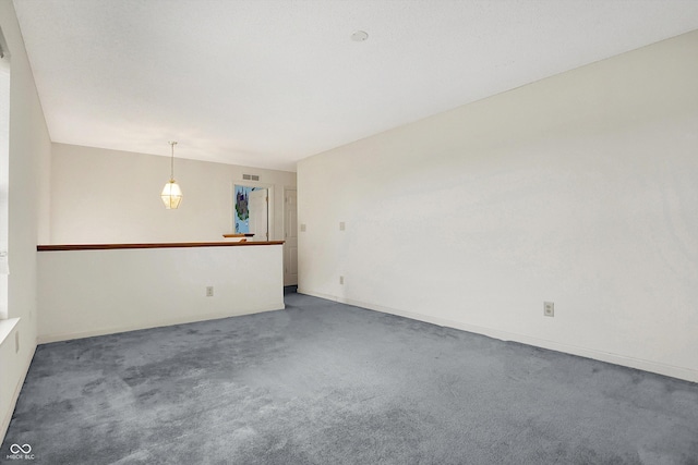 unfurnished room featuring baseboards, visible vents, and carpet floors