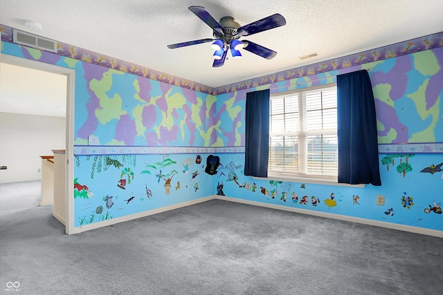 spare room with visible vents, a textured ceiling, and wallpapered walls