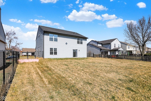 rear view of house featuring a yard and fence private yard