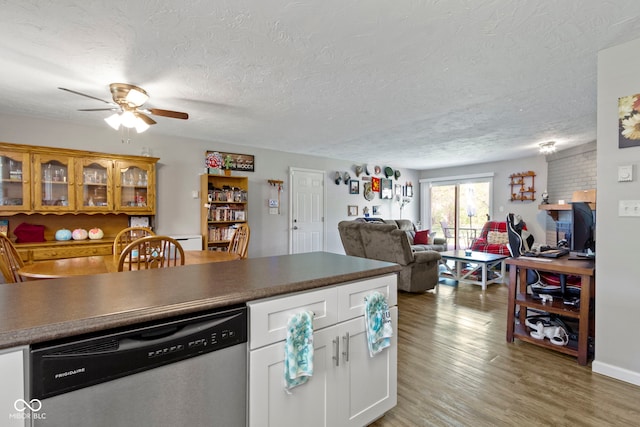 kitchen with white cabinets, a ceiling fan, a textured ceiling, and dishwasher