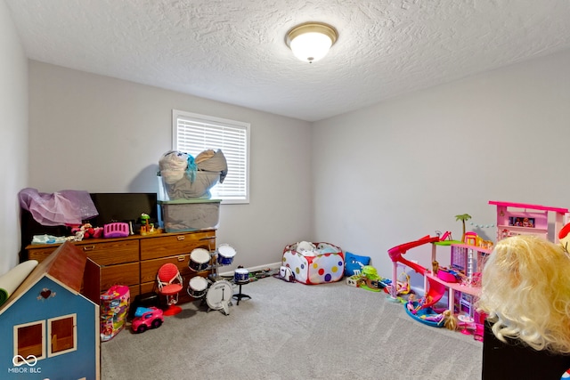 playroom with carpet flooring and a textured ceiling