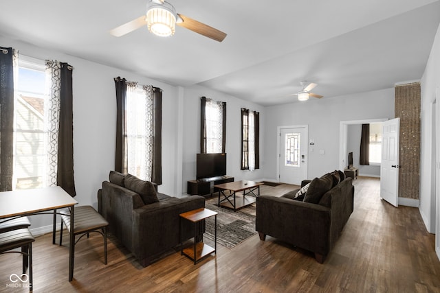 living room with plenty of natural light and wood finished floors