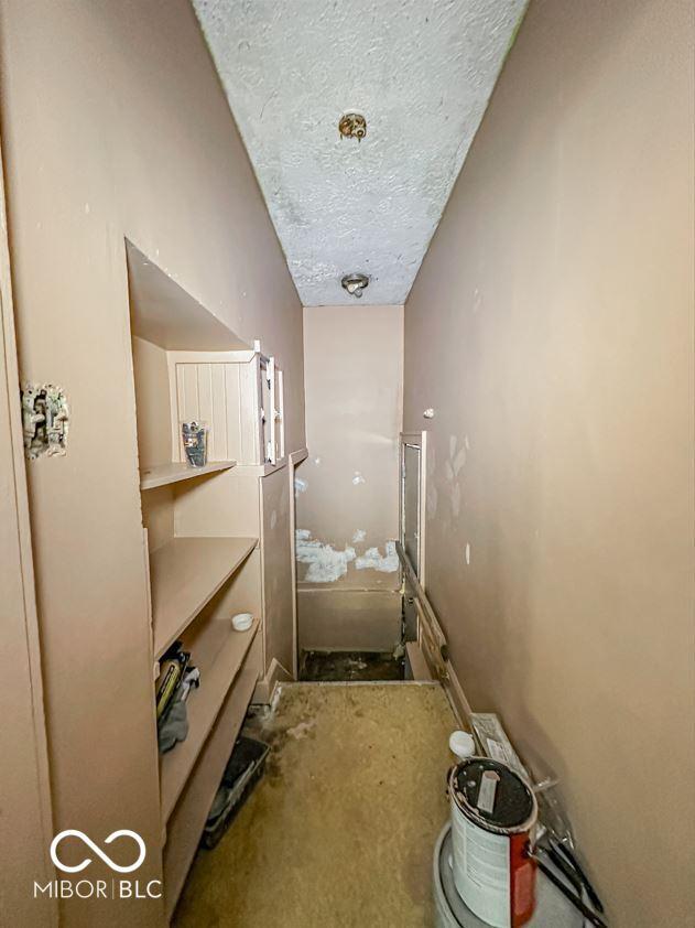 hallway featuring a textured ceiling