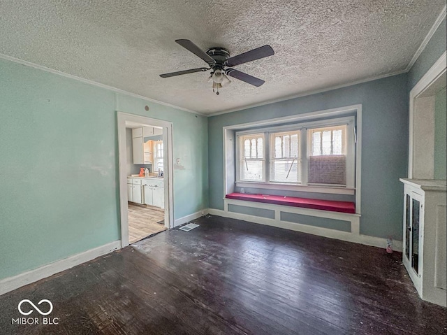 interior space with hardwood / wood-style floors, baseboards, and ornamental molding