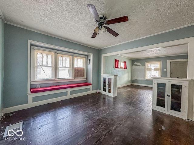 unfurnished living room with hardwood / wood-style flooring, crown molding, and baseboards