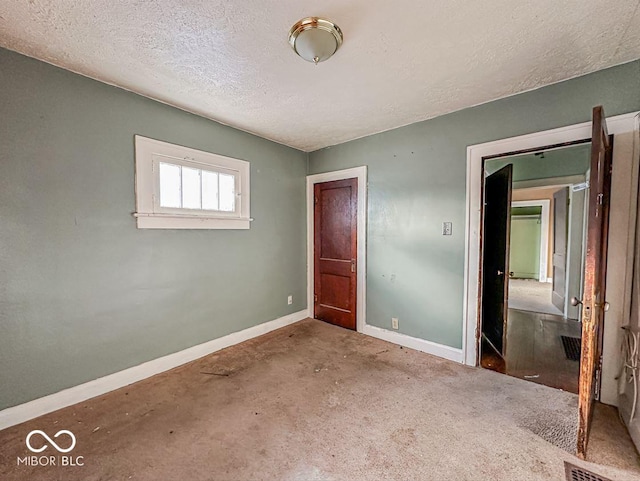 unfurnished bedroom with visible vents, baseboards, and a textured ceiling