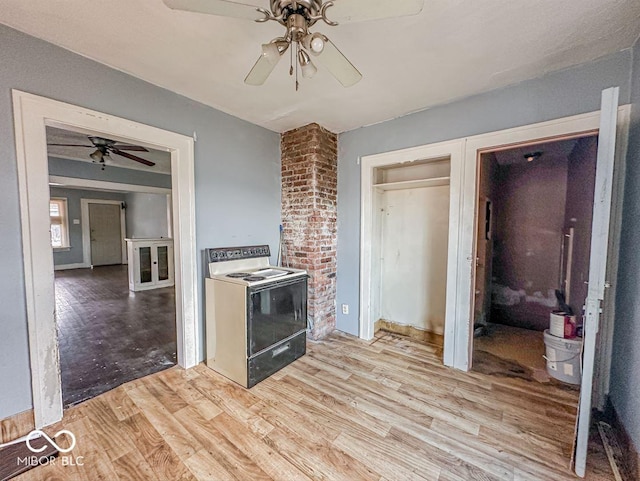 kitchen featuring light wood-type flooring, ceiling fan, and white range with electric cooktop