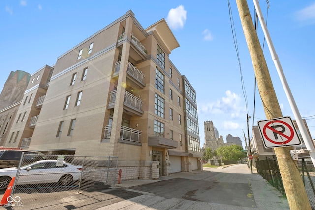 view of building exterior with fence