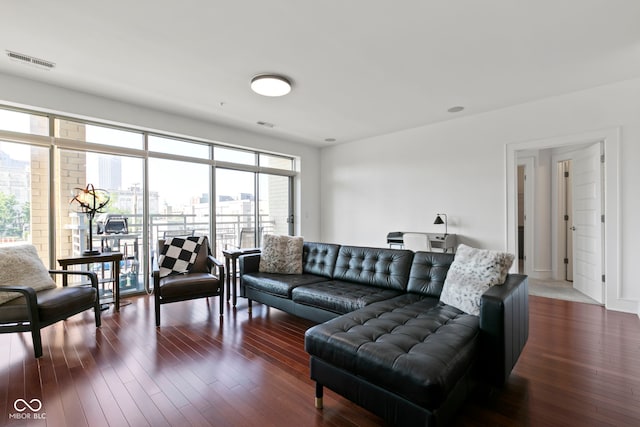 living area with visible vents and dark wood finished floors