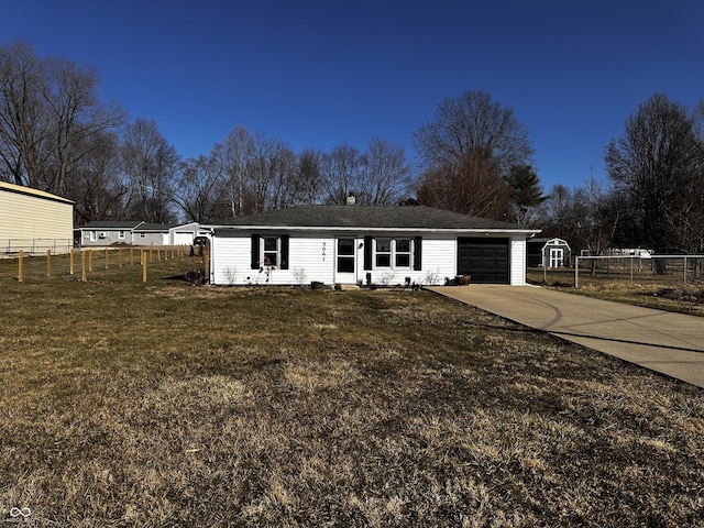 view of front of property featuring a garage, a front lawn, driveway, and fence