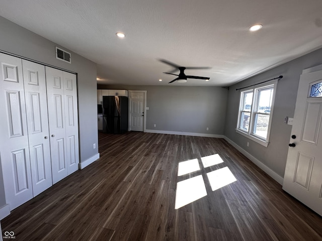 unfurnished living room featuring recessed lighting, dark wood-style floors, visible vents, and baseboards