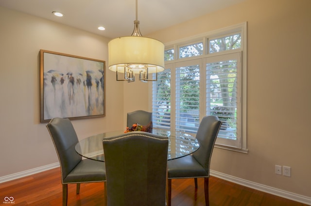 dining space featuring baseboards, wood finished floors, and recessed lighting