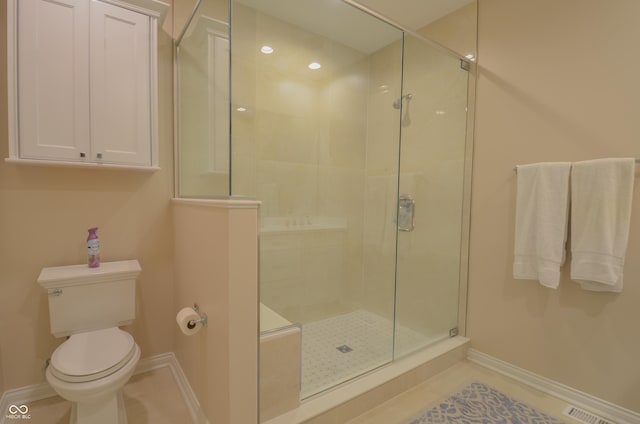 bathroom with toilet, visible vents, baseboards, and a shower stall