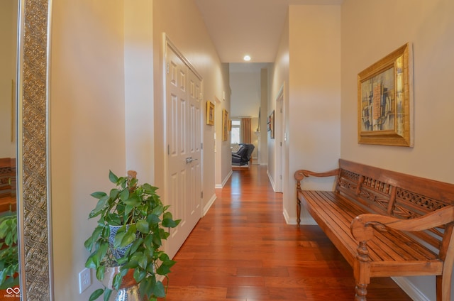 hallway featuring baseboards and wood finished floors