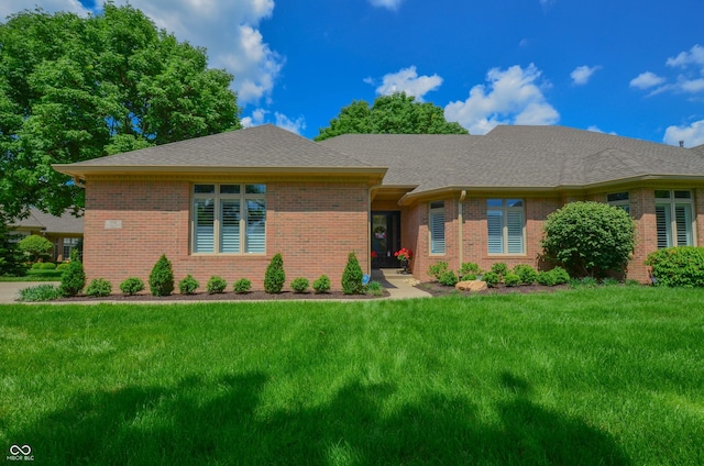 single story home featuring a front lawn, brick siding, and roof with shingles
