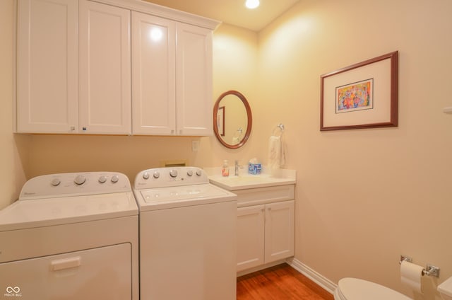 laundry room featuring light wood-style flooring, baseboards, laundry area, recessed lighting, and washer and dryer