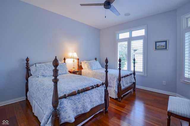 bedroom with baseboards, wood finished floors, and a ceiling fan