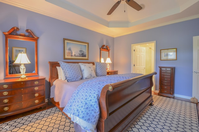 bedroom with baseboards, ceiling fan, ornamental molding, and a raised ceiling