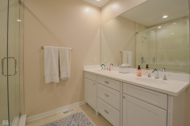 full bathroom featuring a shower stall, visible vents, and a sink