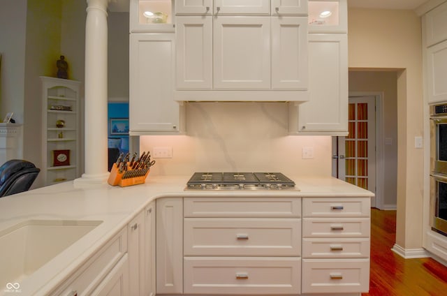 kitchen with white cabinetry, stainless steel gas cooktop, and light countertops