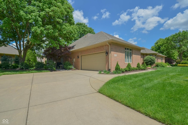 ranch-style home featuring concrete driveway, roof with shingles, an attached garage, a front yard, and brick siding