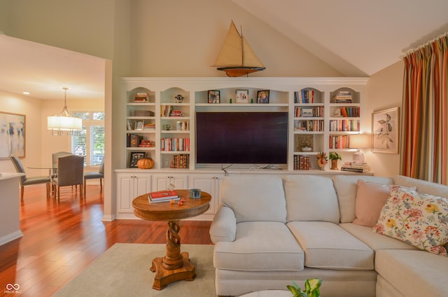 living area with high vaulted ceiling and wood finished floors