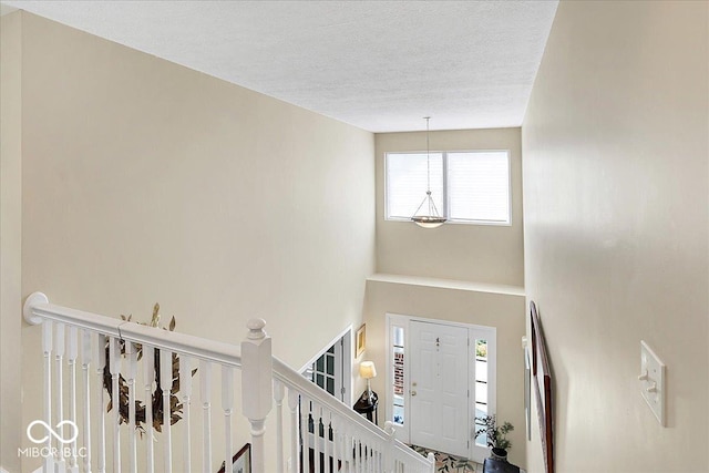 entrance foyer featuring a textured ceiling and a towering ceiling