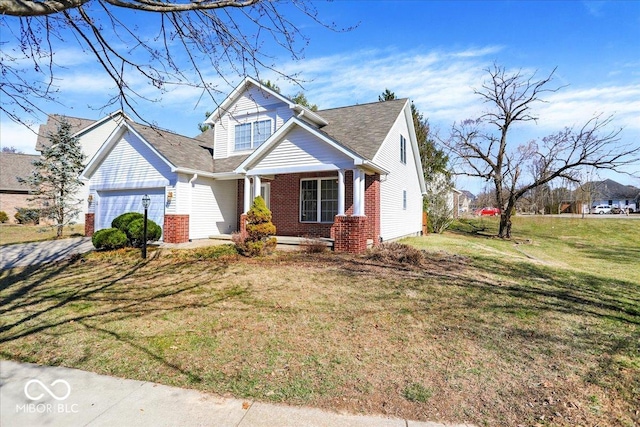 view of front of property featuring a front yard, a garage, and brick siding