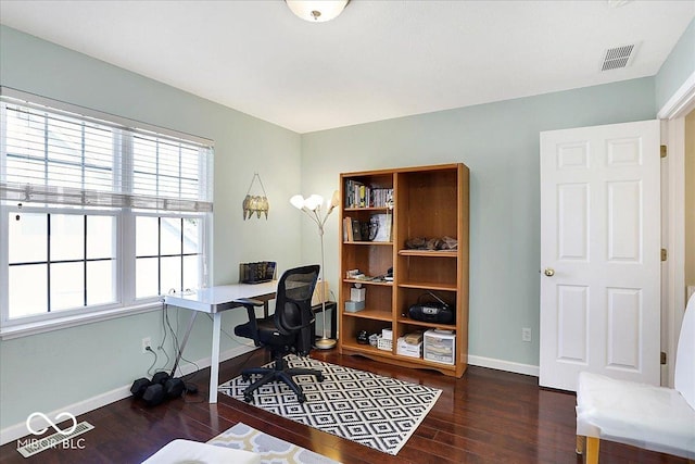 office space featuring wood finished floors, visible vents, and baseboards