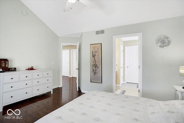 bedroom with vaulted ceiling, visible vents, baseboards, and wood finished floors