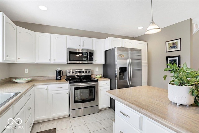 kitchen featuring light countertops, white cabinets, and appliances with stainless steel finishes