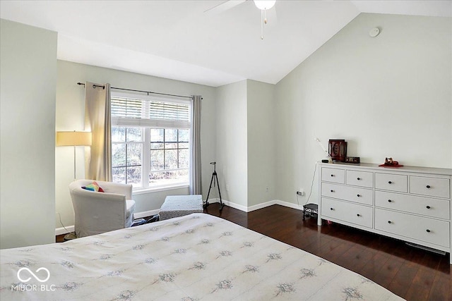 bedroom with baseboards, dark wood-type flooring, and lofted ceiling