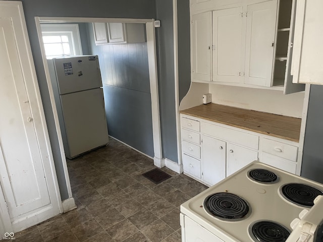 kitchen featuring white appliances, white cabinets, and visible vents